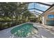 Beautiful pool area with screened enclosure and landscaping, perfect for outdoor enjoyment at 5023 Brickell Park Cv, Bradenton, FL 34211