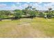 Aerial view features community soccer field with goal and surrounding green spaces and mature trees at 5023 Brickell Park Cv, Bradenton, FL 34211