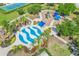 Aerial view of a community splash pad and playground surrounded by lush landscaping at 5023 Brickell Park Cv, Bradenton, FL 34211