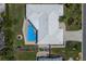 Aerial view of the property showcasing its layout, pool, and surrounding landscape with unique roofline at 508 70Th St, Holmes Beach, FL 34217