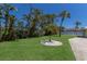 Lush backyard space with a view of the well maintained grass, trees, and surrounding fence at 508 70Th St, Holmes Beach, FL 34217