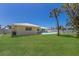 Spacious backyard with ample room for activities and landscaping, and a view of the home at 508 70Th St, Holmes Beach, FL 34217