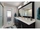 Bathroom with a large mirror, modern cabinets and updated sinks at 508 70Th St, Holmes Beach, FL 34217