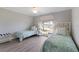 Bright bedroom featuring two twin beds with a ceiling fan and large window at 508 70Th St, Holmes Beach, FL 34217