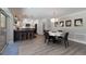 Dining room with hardwood floors, open to the kitchen and a view of the exterior at 508 70Th St, Holmes Beach, FL 34217