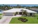 Stunning single-story home with lush lawn, mature palm trees, and white tile roof at 508 70Th St, Holmes Beach, FL 34217