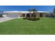 Charming single-story home with landscaped front yard, lush green lawn, and palm trees at 508 70Th St, Holmes Beach, FL 34217