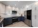 A modern kitchen with stainless steel appliances, two-tone cabinets, and a light hardwood floor at 508 70Th St, Holmes Beach, FL 34217