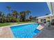 Backyard pool with clear blue water, grassy area and patio seating at 508 70Th St, Holmes Beach, FL 34217