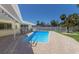 Clear view of the pool area with updated patio and landscaping, plus adjacent covered patio space at 508 70Th St, Holmes Beach, FL 34217