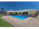 Backyard pool surrounded by landscaping and overlooking the home's covered patio and multiple sliding glass doors at 508 70Th St, Holmes Beach, FL 34217