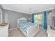 Inviting bedroom with a queen size bed, ceiling fan, gray walls, and bright window views at 5251 Mahogany Run Ave # 521, Sarasota, FL 34241