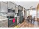 This eat-in kitchen offers stainless steel appliances, granite countertops, and wood flooring at 5251 Mahogany Run Ave # 521, Sarasota, FL 34241