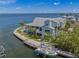 Scenic aerial view of a waterfront home with a private boat dock, lush landscaping, and serene canal access at 526 56Th St, Holmes Beach, FL 34217