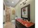 Bathroom with green walls, rustic mirror, and glass enclosed shower with tiled walls at 526 56Th St, Holmes Beach, FL 34217