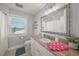 Bathroom with a white vanity, tile floors, and a window offering view to the intercoastal waterway at 526 56Th St, Holmes Beach, FL 34217