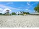 Bright and sunny beach scene, showcasing white sand, a lifeguard tower, and beachside dining under a clear sky at 526 56Th St, Holmes Beach, FL 34217