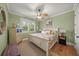 Cozy bedroom with hardwood floors, cottage style decor, and a window with plantation shutters at 526 56Th St, Holmes Beach, FL 34217