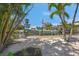 Private boat dock with a boat lift, surrounded by lush tropical foliage and situated on a sunny waterfront at 526 56Th St, Holmes Beach, FL 34217