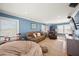 Large living room with blue walls, a red bike, multiple sofas and a TV at 526 56Th St, Holmes Beach, FL 34217
