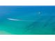 Breathtaking ocean view showcasing a boat and parasail against clear turquoise waters at 526 56Th St, Holmes Beach, FL 34217