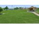 Well-kept community park area with grassy lawn and covered bench seating, suitable for families at 526 56Th St, Holmes Beach, FL 34217