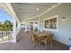 Covered patio with wooden table and chairs for dining or entertaining, providing shelter and comfort at 526 56Th St, Holmes Beach, FL 34217