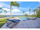 Tranquil waterfront pool with spa, deck chairs, and palm trees providing a luxurious outdoor experience at 526 56Th St, Holmes Beach, FL 34217