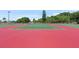 Well-maintained tennis courts ready for a match, surrounded by lush greenery at 526 56Th St, Holmes Beach, FL 34217