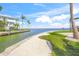 Stunning waterfront scenery with a canal, lush greenery, and beach, capturing the beauty of coastal living at 526 56Th St, Holmes Beach, FL 34217