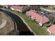 A beautiful aerial view of a condo overlooking a serene waterway and lush green landscaping at 5630 Golf Pointe Dr # 206, Sarasota, FL 34243