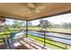 A covered balcony has comfortable seating with lovely views of water and a golf course at 5630 Golf Pointe Dr # 206, Sarasota, FL 34243