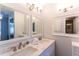 Bright bathroom featuring double sinks, vanity cabinets, and mirrors for a functional and stylish space at 5630 Golf Pointe Dr # 206, Sarasota, FL 34243