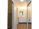 This hallway features a full bathroom with double sinks and mirrors at 5630 Golf Pointe Dr # 206, Sarasota, FL 34243