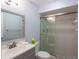 This bathroom features a vanity with sliding glass shower doors at 5630 Golf Pointe Dr # 206, Sarasota, FL 34243