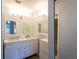 Well lit bathroom with dual sinks, mirrors, and vanity cabinets, offering ample space and a clean aesthetic at 5630 Golf Pointe Dr # 206, Sarasota, FL 34243