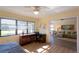 Bedroom with a window with bright natural light and a view into the living room at 5630 Golf Pointe Dr # 206, Sarasota, FL 34243