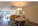Charming dining area with hardwood floors adjacent to the well-lit living room and serene balcony view at 5630 Golf Pointe Dr # 206, Sarasota, FL 34243