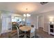 A dining room features a round table with four chairs, chandelier and large mirror at 5630 Golf Pointe Dr # 206, Sarasota, FL 34243