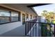 Balcony view of the exterior walkways with lush landscaping and palm trees at 5630 Golf Pointe Dr # 206, Sarasota, FL 34243