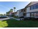 Exterior view of multi-unit condo building showcasing well-maintained landscaping, parking, and architectural design at 5630 Golf Pointe Dr # 206, Sarasota, FL 34243