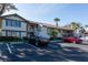 Inviting condo exterior with parking and mature landscaping for a serene residential appeal at 5630 Golf Pointe Dr # 206, Sarasota, FL 34243
