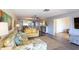 Spacious living room featuring an open floor plan and seamless flow to the bedroom and outdoor balcony at 5630 Golf Pointe Dr # 206, Sarasota, FL 34243