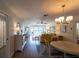 Open concept living room to dining area with hardwood floors at 5630 Golf Pointe Dr # 206, Sarasota, FL 34243