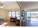 Open living space with a view of golf course featuring wood floors, ceiling fan, window, and flat screen TV at 5630 Golf Pointe Dr # 206, Sarasota, FL 34243