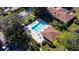 Aerial view of a sparkling swimming pool with lounge chairs and tropical landscaping at 5630 Golf Pointe Dr # 206, Sarasota, FL 34243