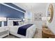 Bedroom with blue accent wall, stylish decor, and a well-lit window at 5632 Summit Pointe Cir # 101, Bradenton, FL 34210