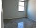 Compact bedroom featuring tile flooring, a window, and light walls and trim at 5632 Summit Pointe Cir # 101, Bradenton, FL 34210