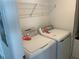 Functional laundry room equipped with modern washer and dryer units and storage shelf at 5632 Summit Pointe Cir # 101, Bradenton, FL 34210
