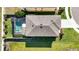 Aerial view showcases the property's roof and screened-in pool area within the landscaped backyard and neighborhood at 5800 Elegant Orchid Way, Sarasota, FL 34232